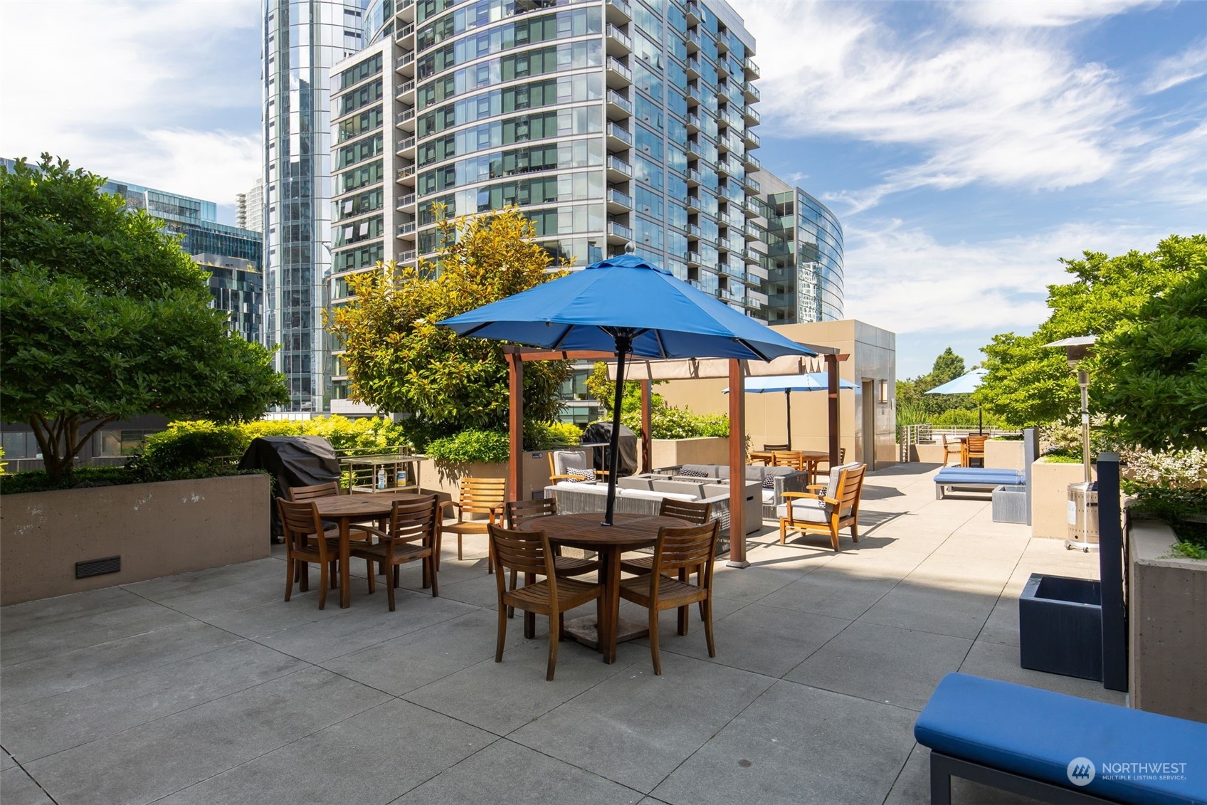 910 Lenora Street, Unit S310 Seattle, WA 98121 - Photo 35 of 40 a patio with a patio table and chairs