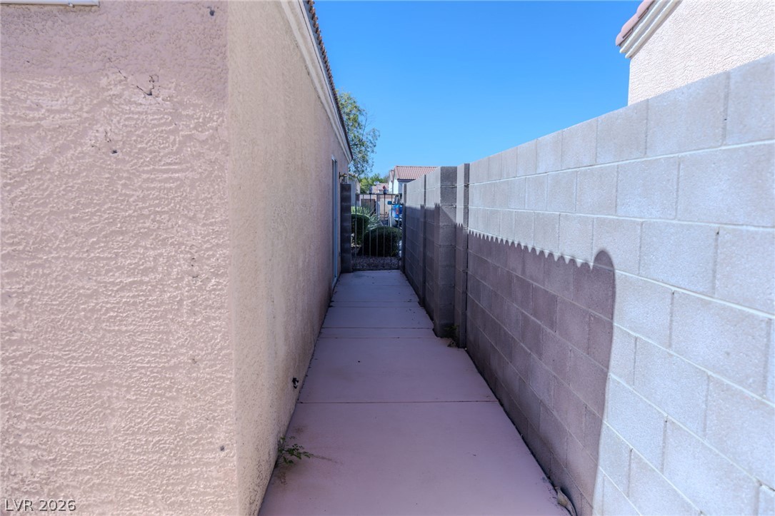4994 Mascaro Drive Las Vegas, NV 89122 - Photo 25 of 30 A well-maintained pathway between structures offers private access to the backyard.