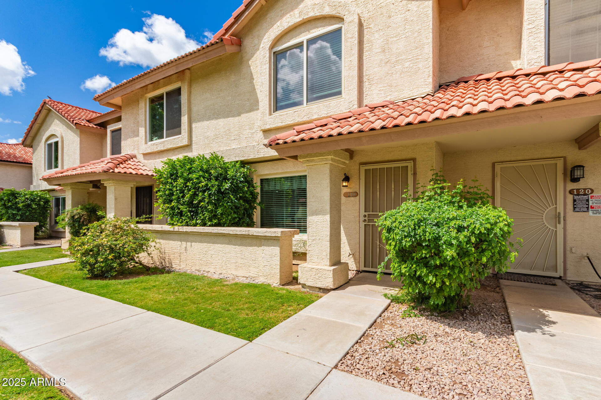 5808 East Brown Road, Unit 119 Mesa, AZ 85205 - Photo 1 of 12 a front view of a house with garden