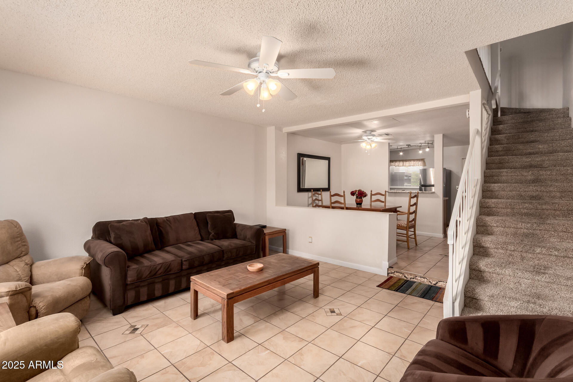 5808 East Brown Road, Unit 119 Mesa, AZ 85205 - Photo 2 of 12 a living room with furniture and a wooden floor