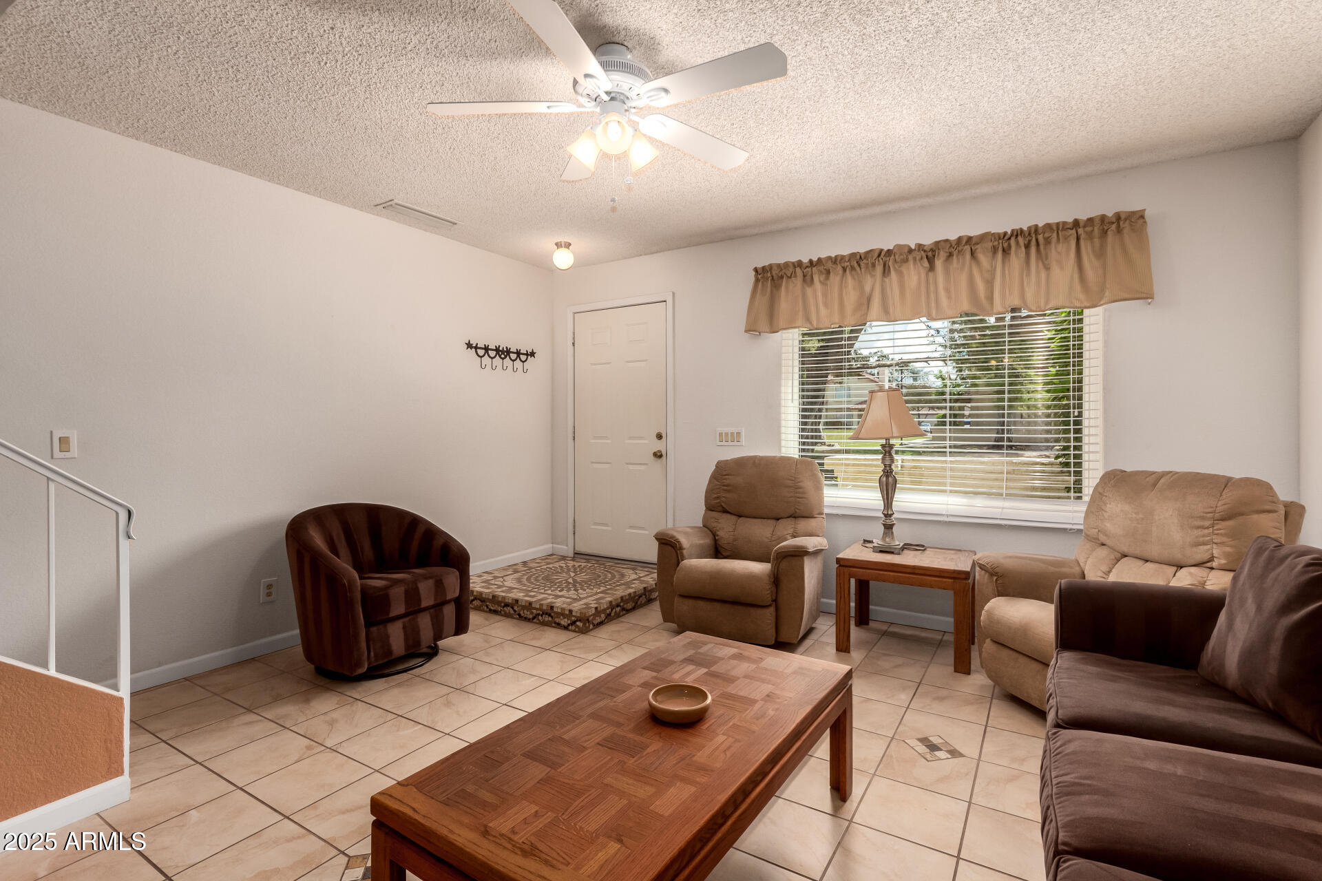 5808 East Brown Road, Unit 119 Mesa, AZ 85205 - Photo 3 of 12 a living room with furniture and a large window