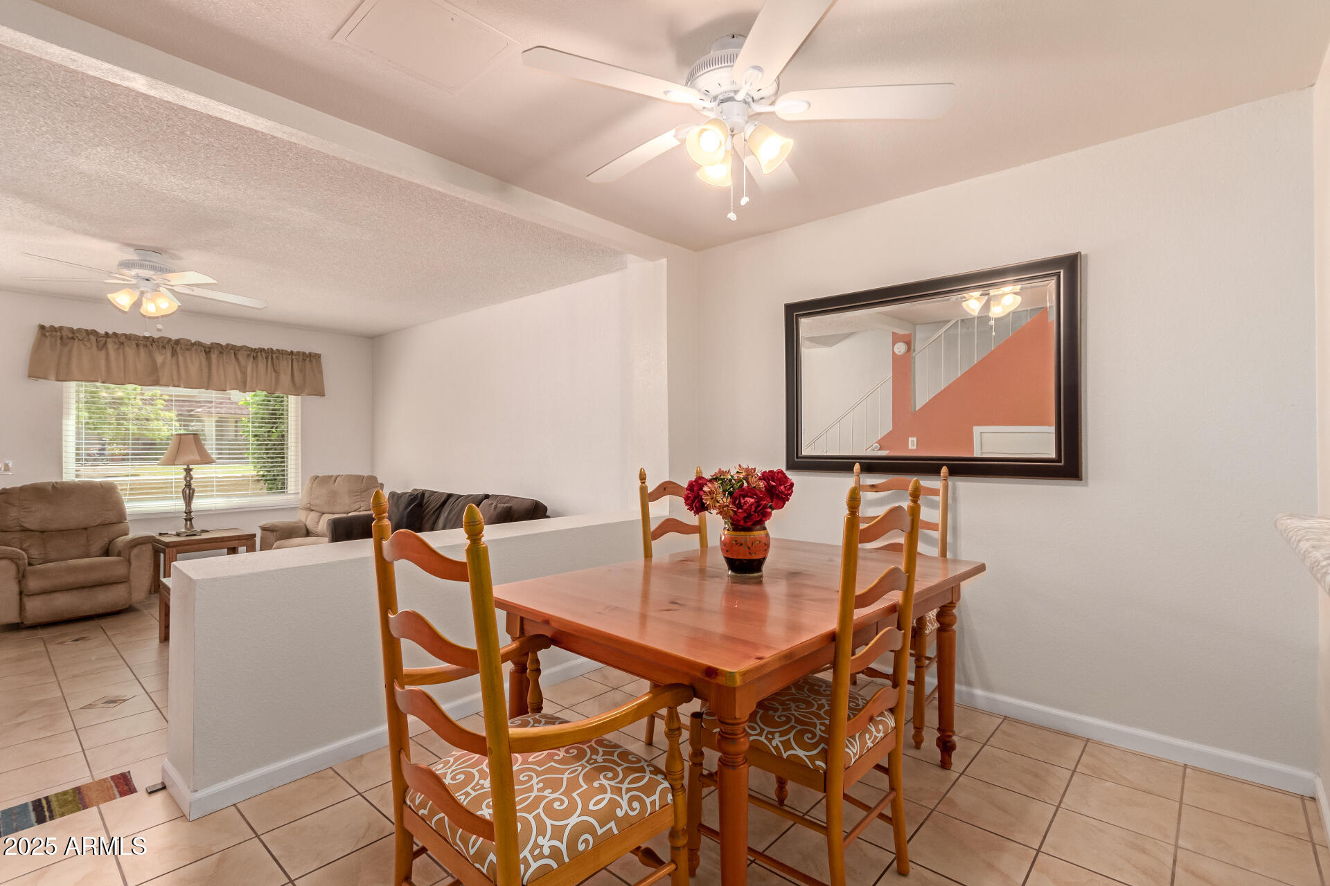5808 East Brown Road, Unit 119 Mesa, AZ 85205 - Photo 4 of 12 a view of a dining room with furniture and a window