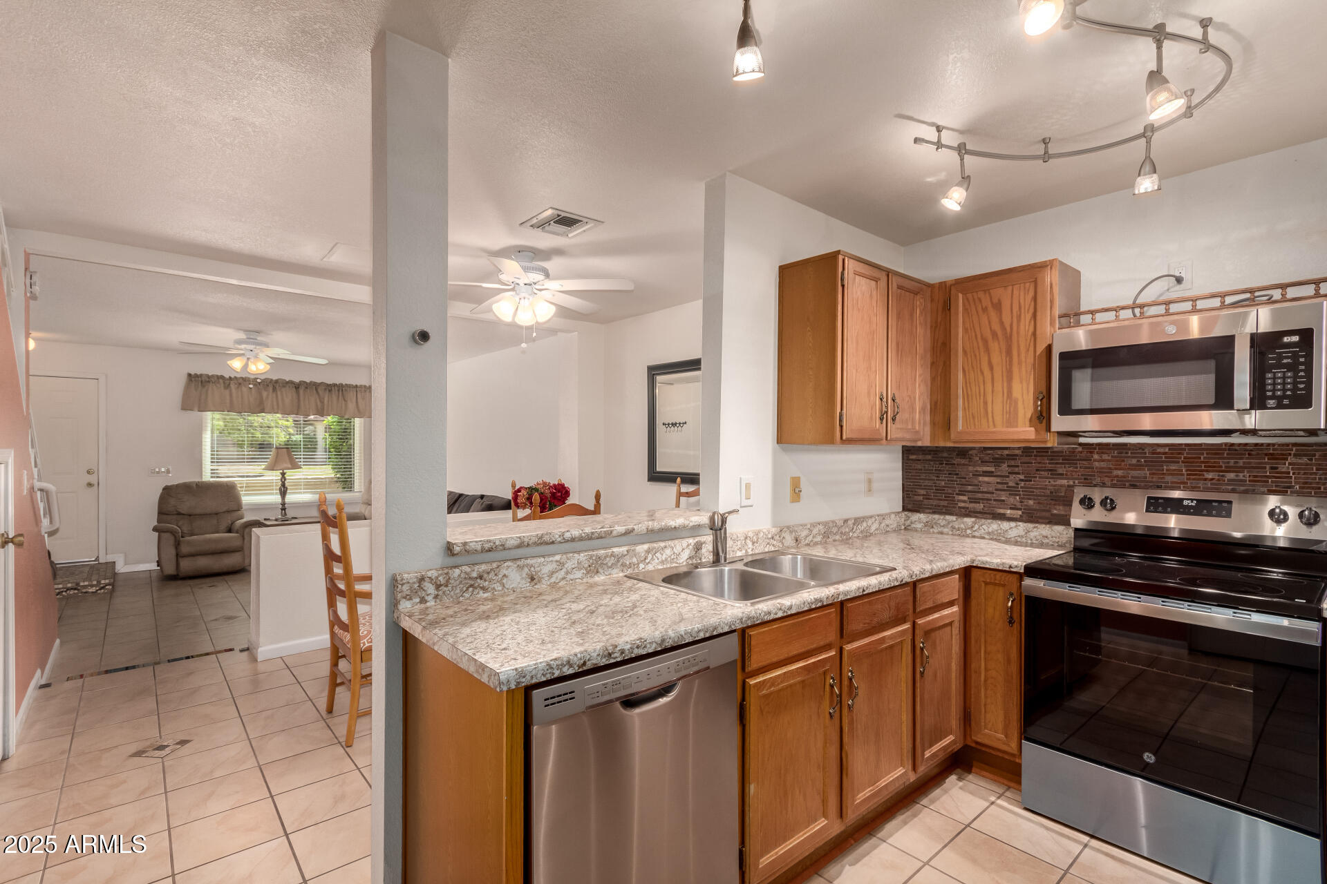5808 East Brown Road, Unit 119 Mesa, AZ 85205 - Photo 5 of 12 a kitchen with a sink stove and cabinets