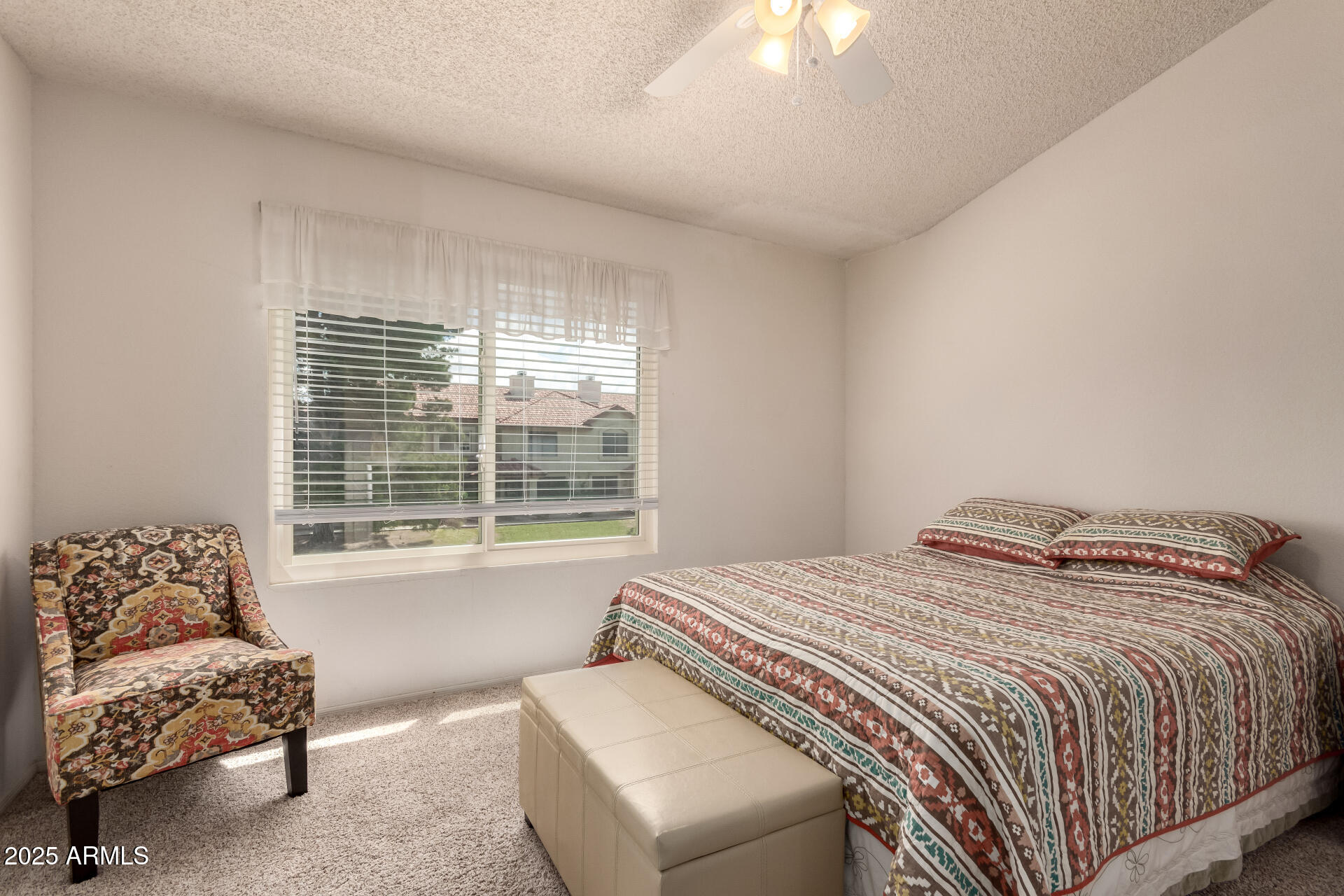 5808 East Brown Road, Unit 119 Mesa, AZ 85205 - Photo 10 of 12 a bedroom with a bed and a couch