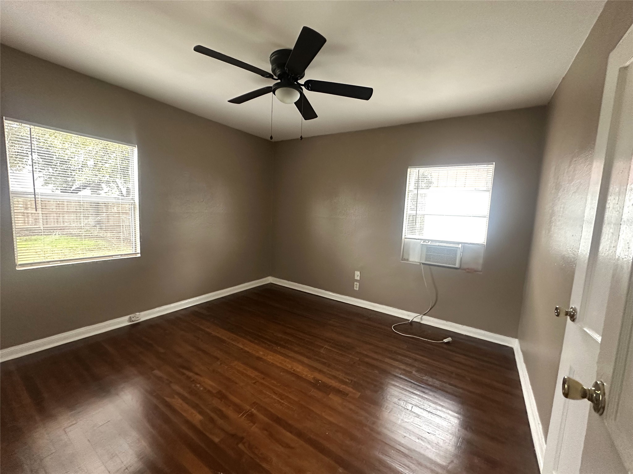 11005 Muscatine Street Houston, TX 77029 - Photo 8 of 12 wooden floor in an empty room with a window