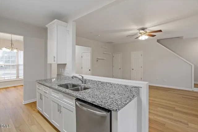 a kitchen with stainless steel appliances granite countertop a sink dishwasher and stove