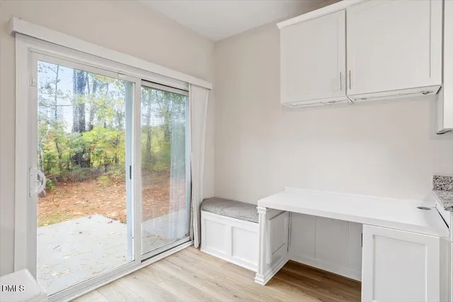 a room with a wooden floor and white walls