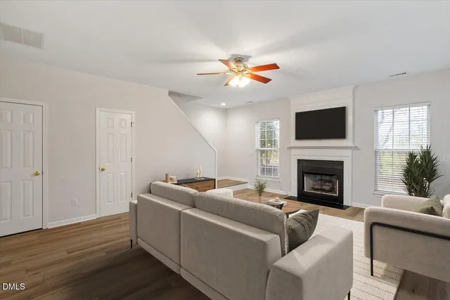 a living room with furniture a fireplace and a flat screen tv