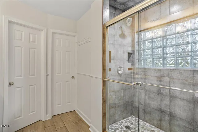 a bathroom with a glass shower door