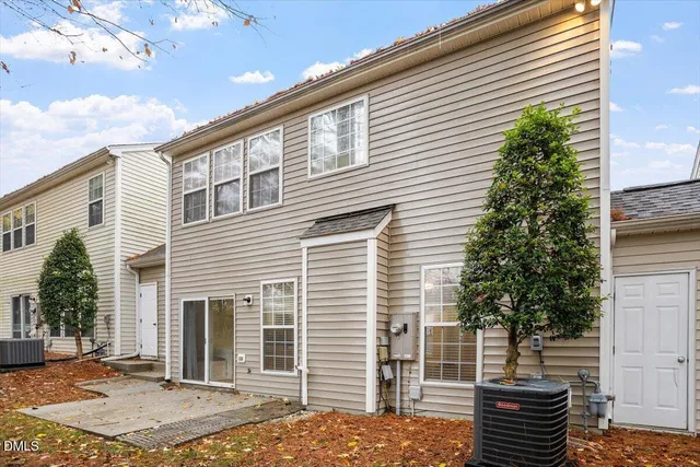 a front view of a house with plants