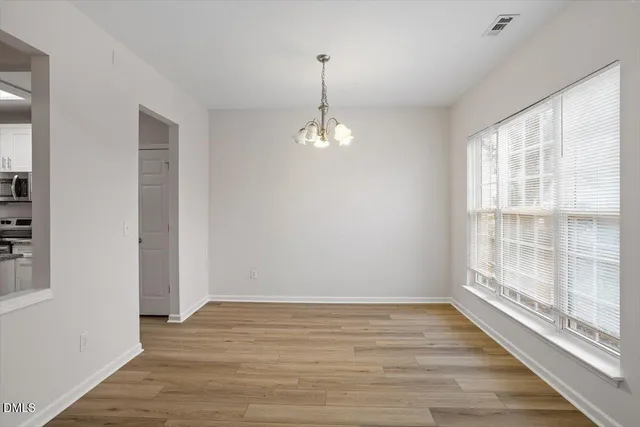 a view of a room with wooden floor and windows