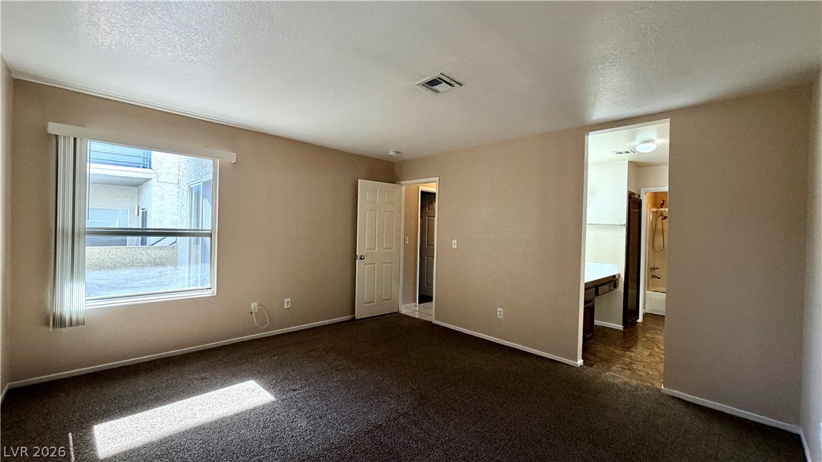 6250 West Flamingo Road, Unit 4 Las Vegas, NV 89103 - Photo 18 of 45 This spacious bedroom offers ample natural light and a seamless flow into the private bath.