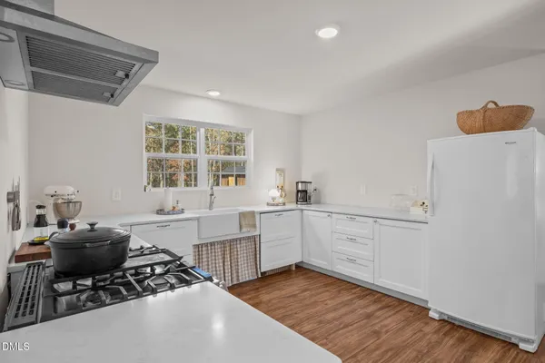 a kitchen with a sink appliances and cabinets