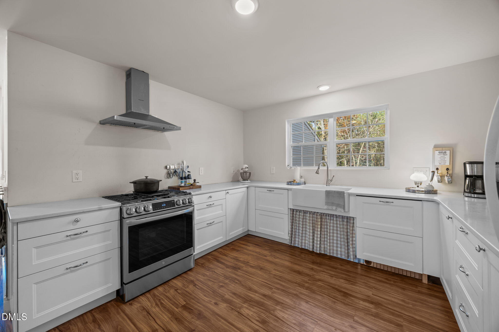 499 Jumping Run Road Dunn, NC 28334 - Photo 12 of 42 a kitchen with cabinets wooden floor and stainless steel appliances