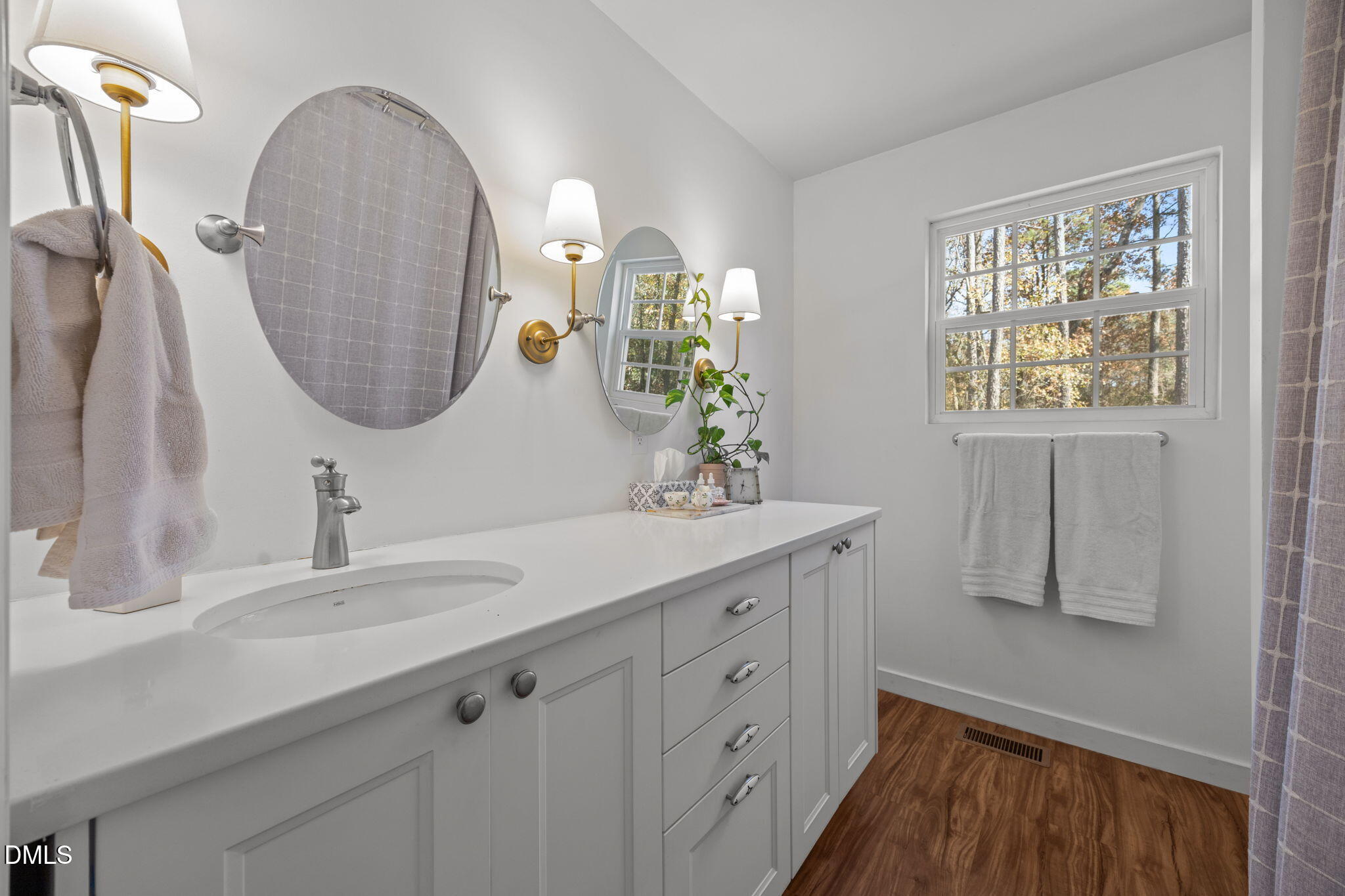 499 Jumping Run Road Dunn, NC 28334 - Photo 17 of 42 a bathroom with a double vanity sink and a mirror