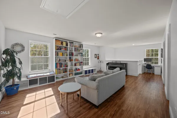 a living room with furniture and a book shelf
