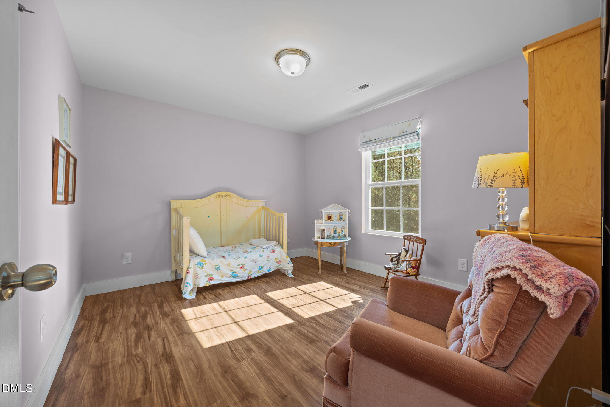 499 Jumping Run Road Dunn, NC 28334 - Photo 22 of 42 a bedroom with a bed and wooden floor