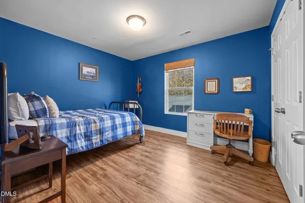 a bedroom with furniture and a window