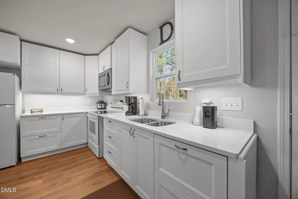 a kitchen with a sink cabinets and window