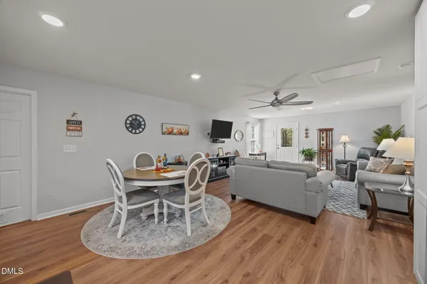 a living room with furniture a wooden floor and a table