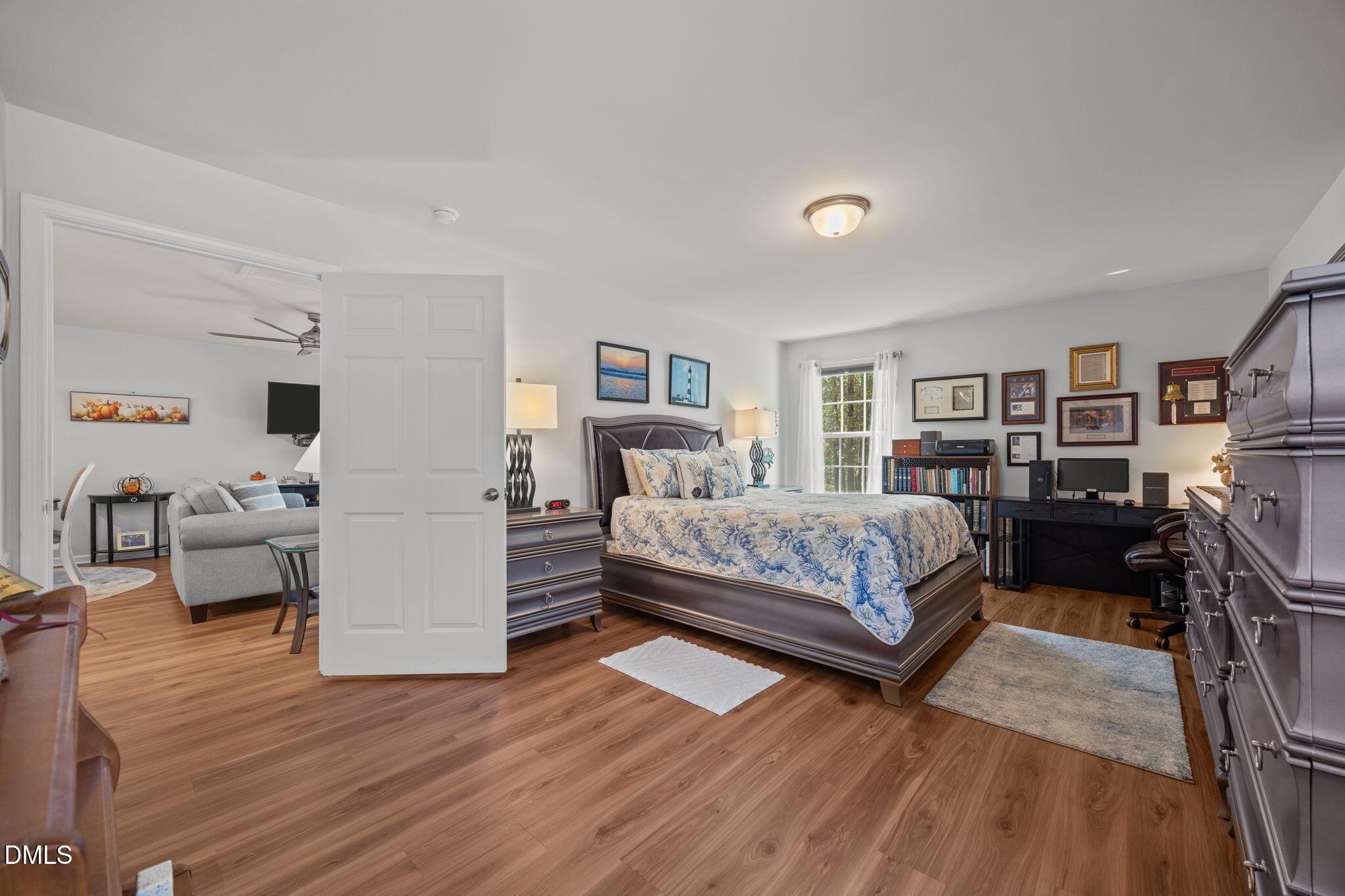 499 Jumping Run Road Dunn, NC 28334 - Photo 34 of 42 a bedroom with a bed and furniture with wooden floor