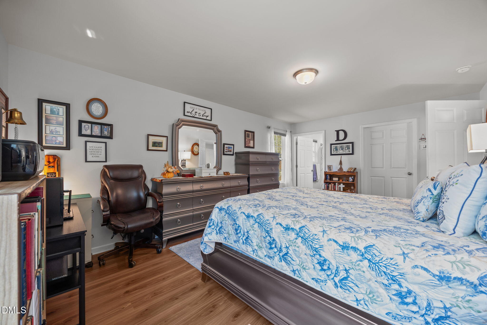 499 Jumping Run Road Dunn, NC 28334 - Photo 35 of 42 a bedroom with a bed and wooden floor