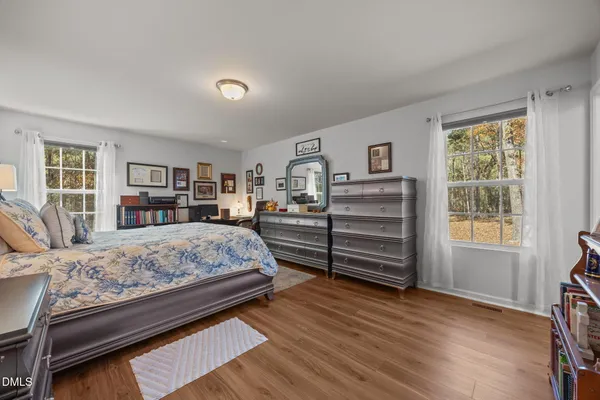 a bedroom with a bed closet and a window