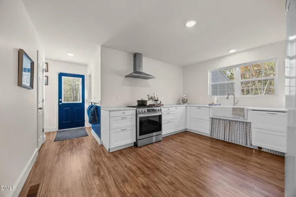 a kitchen with stainless steel appliances a white stove top oven and a refrigerator