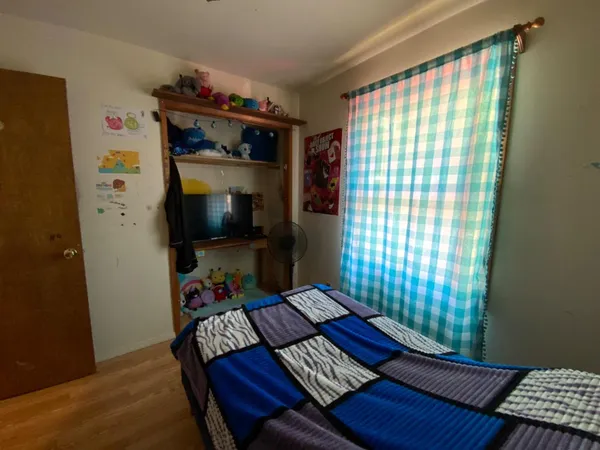 a bedroom with a bed and a window