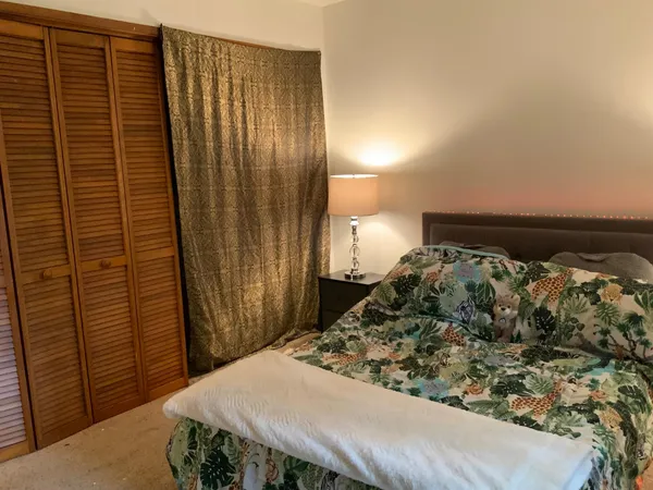 a bed room with furniture and a flat screen tv