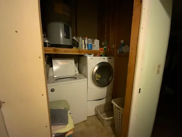 an empty room with furniture and a flat screen tv