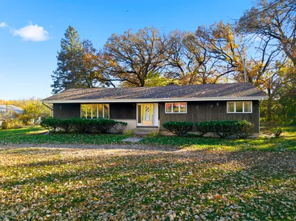 a front view of a house with a yard and porch