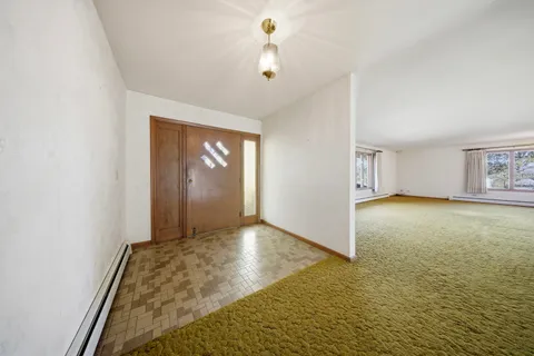 a large kitchen with a large window and stainless steel appliances