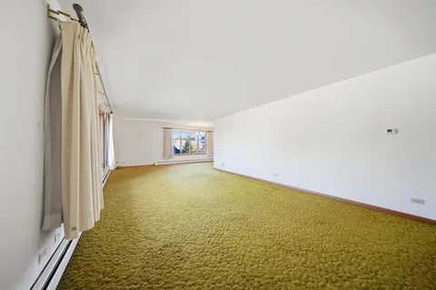 a view of an empty room with a fireplace