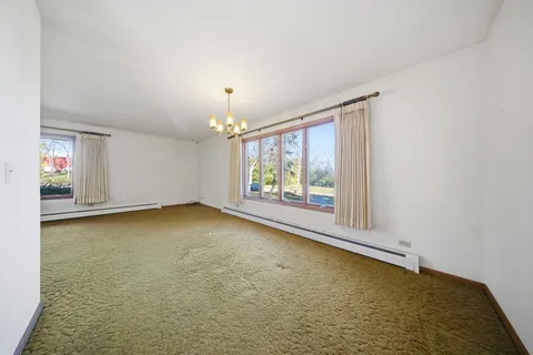 a view of a livingroom with wooden floor and a fireplace