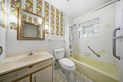 a view of empty room with stairs and mirrors