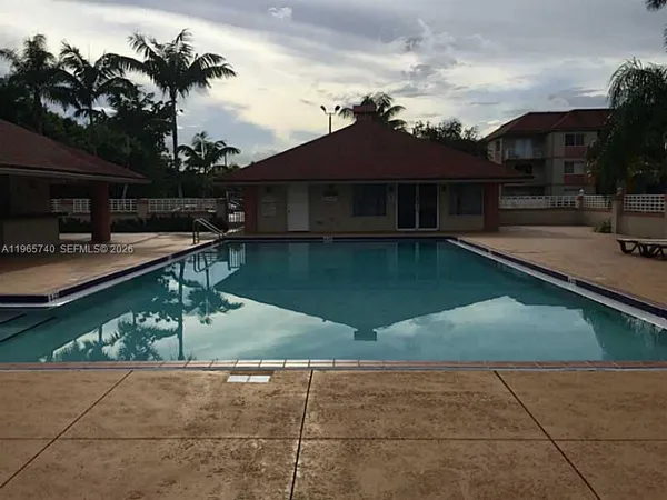 a house view with a swimming pool and sitting space