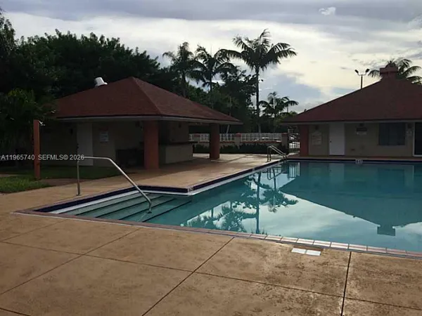 a view of house with swimming pool yard slide and outdoor seating