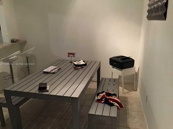 a kitchen with a sink and a stove with wooden floor