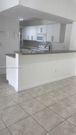 a kitchen with a sink cabinets and appliances