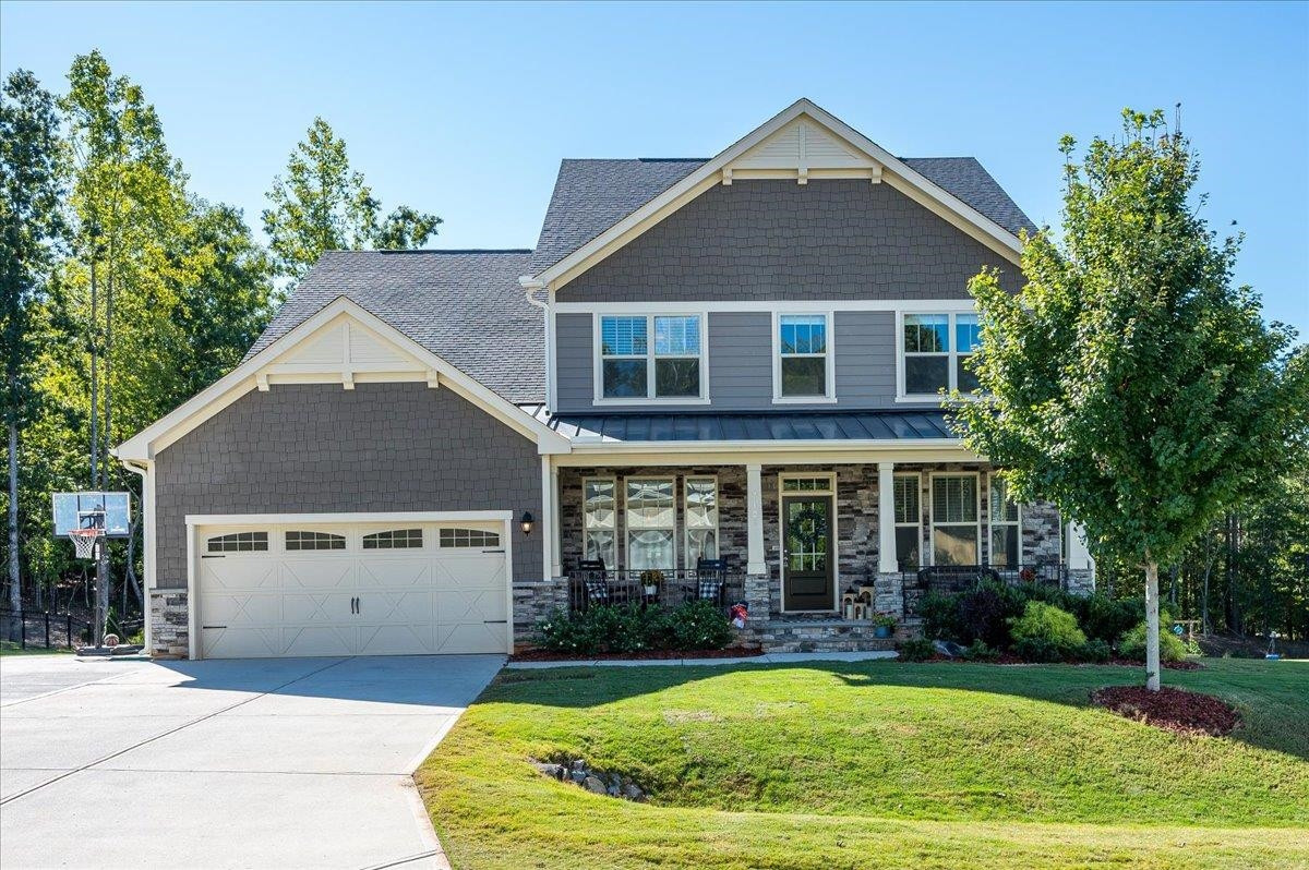 Full front porch for casual sitting and enjoying time outdoors. Gorgeous home