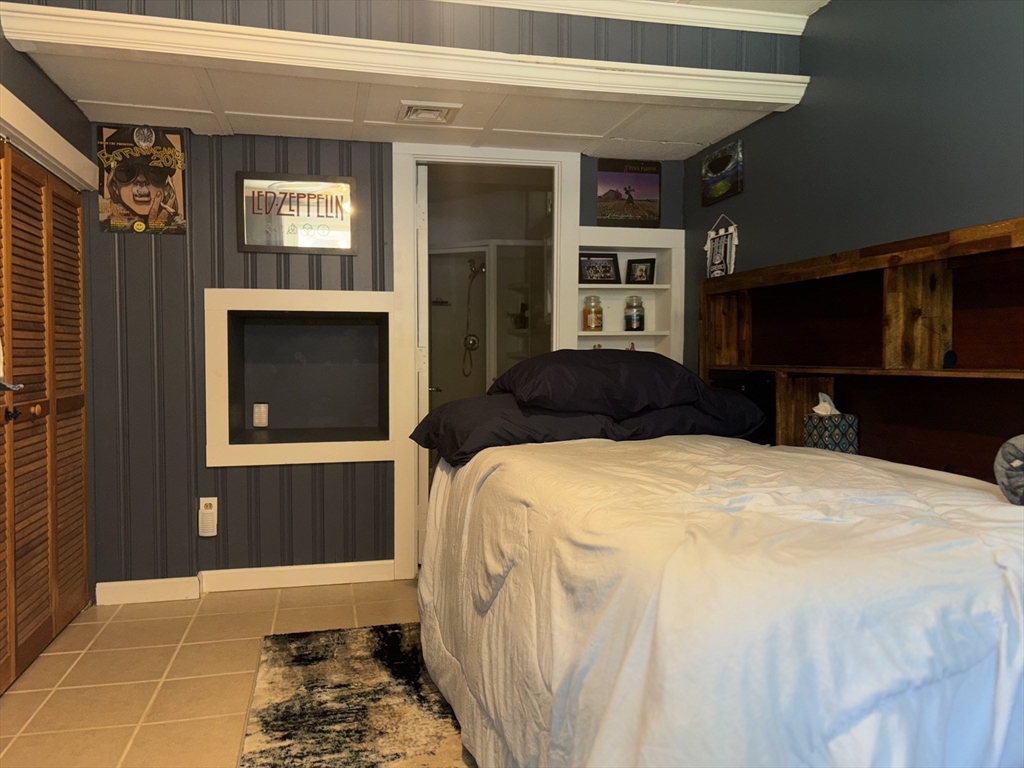 657 Pleasant Street Rochdale, MA 01542 - Photo 23 of 28 a bedroom with a bed and a dresser