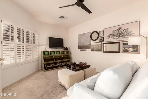 a living room with furniture and a ceiling fan