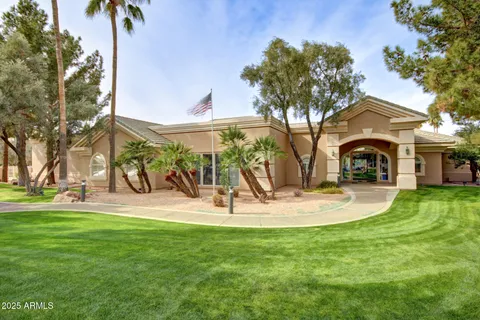 a front view of a house with a yard and trees