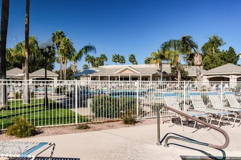 a view of a swimming pool with a lawn chairs