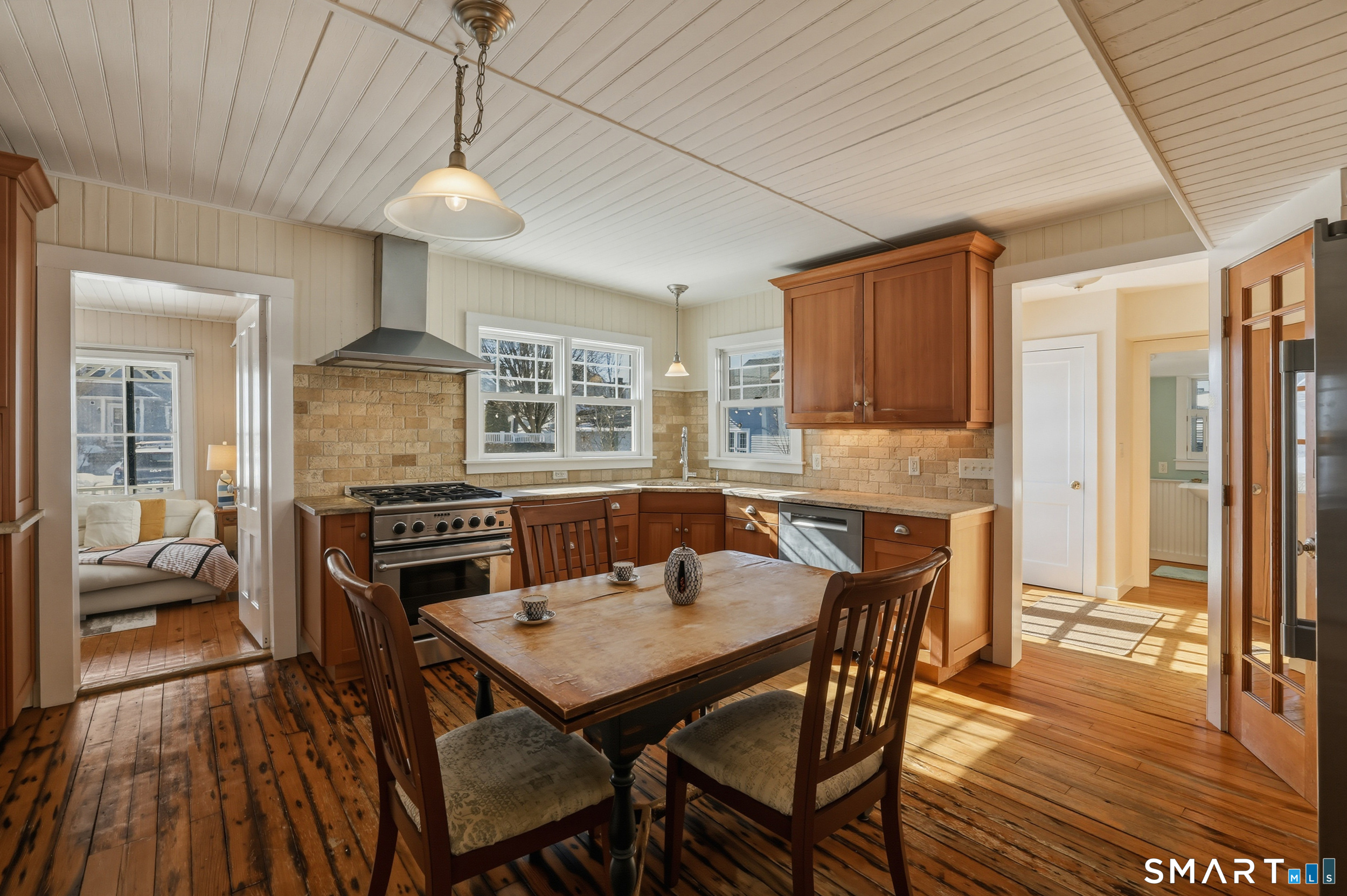 11 Tuxis Road Madison, CT 06443 - Photo 14 of 40 The eat-in kitchen also features shiplap walls and ceiling, rustic wood flooring, and a DCS oven with 5-burner gas cooktop.