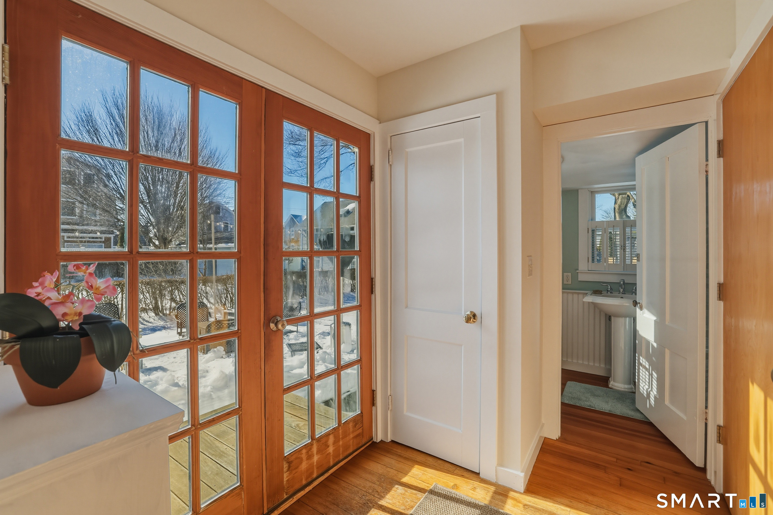 11 Tuxis Road Madison, CT 06443 - Photo 15 of 40 Mudroom with wood flooring, backyard access, and convenient entry to the utility closet and full bath.