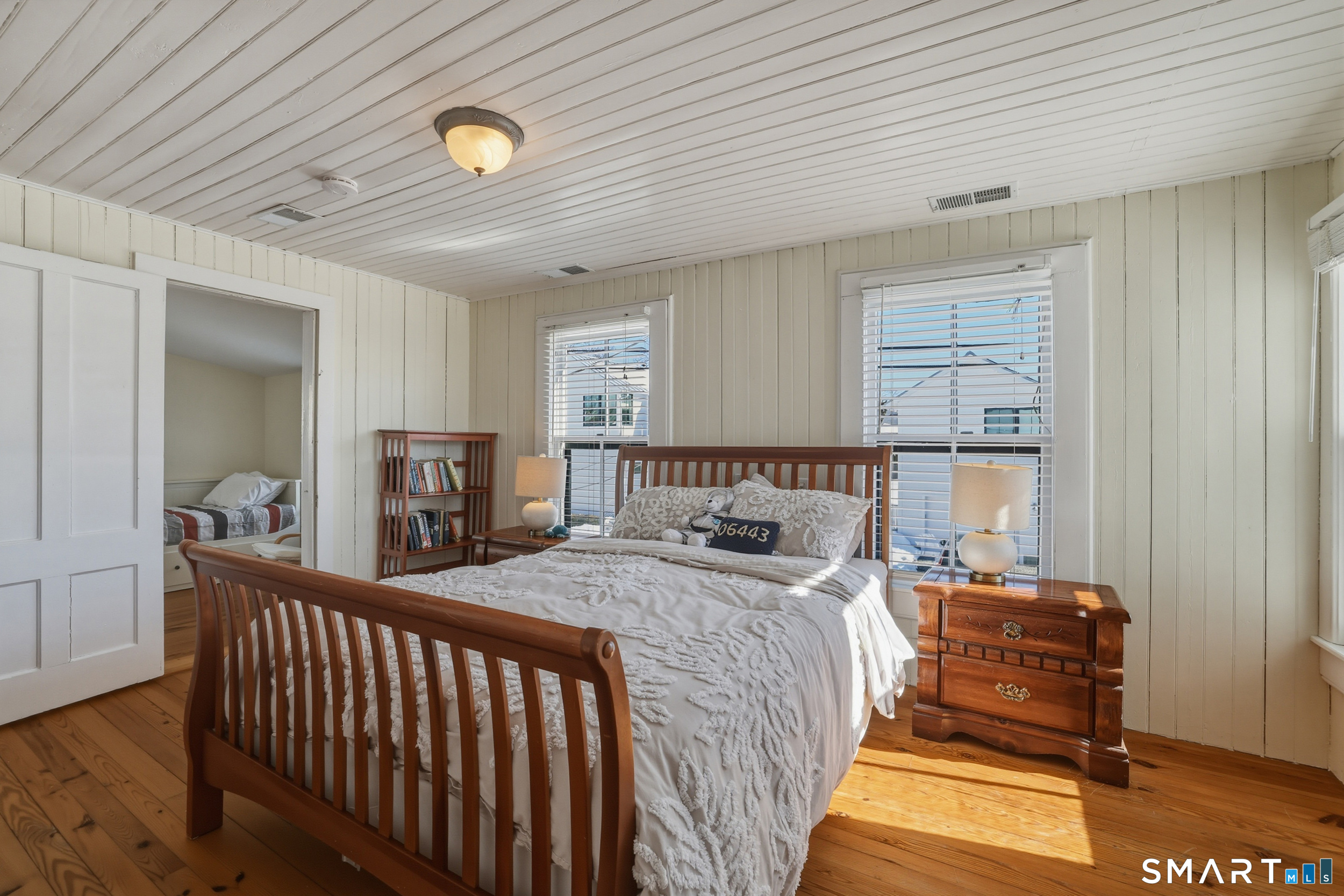 11 Tuxis Road Madison, CT 06443 - Photo 18 of 40 Master bedroom ~ wood flooring, bead-board walls and ceilings, with water views.