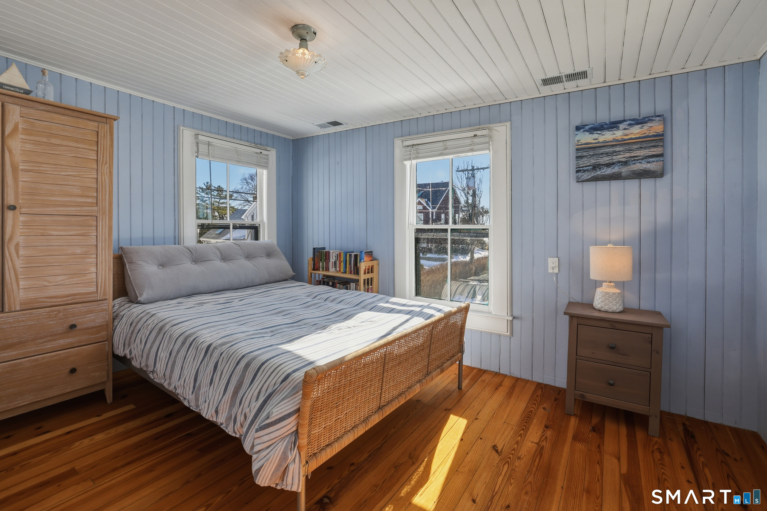 11 Tuxis Road Madison, CT 06443 - Photo 20 of 40 Bedroom #2 also with wood flooring, bead-board, and view of Long Island Sound.