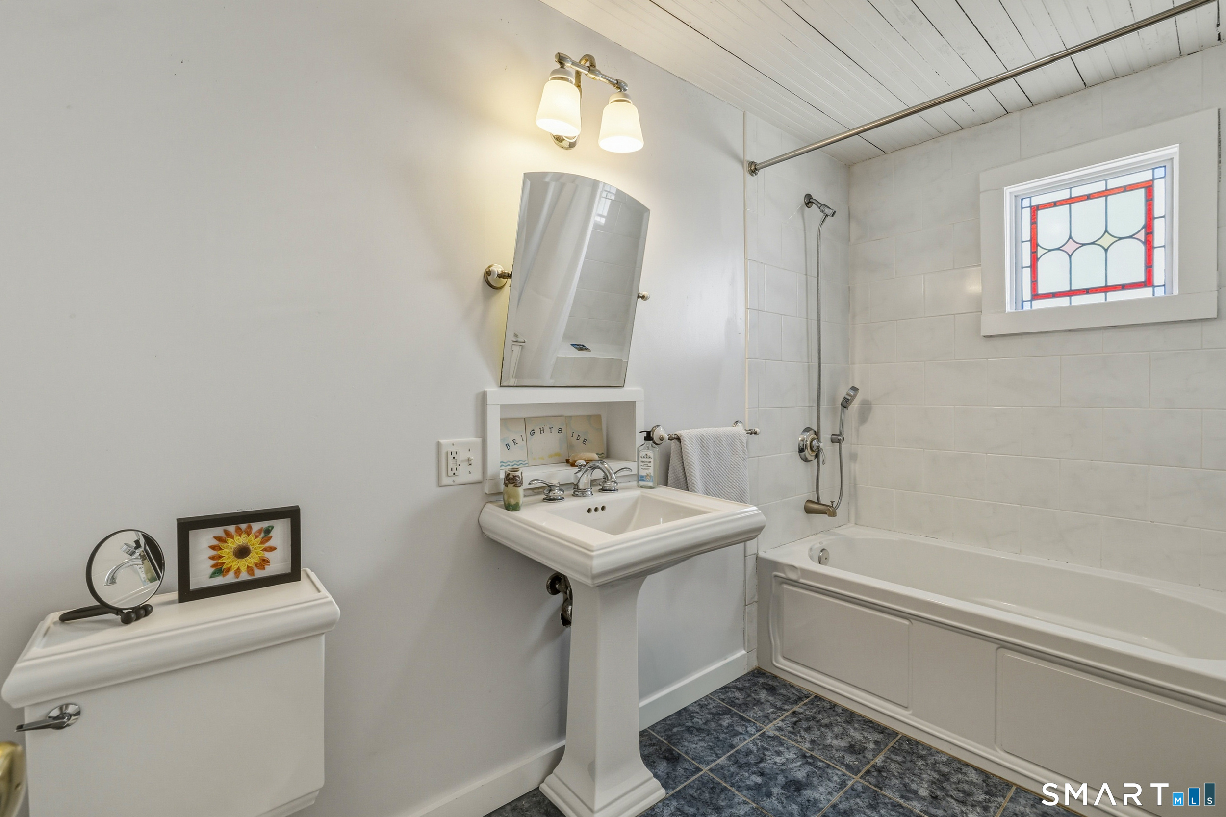 11 Tuxis Road Madison, CT 06443 - Photo 25 of 40 Full bath on upper level with tile flooring, combination tub/shower with tile surround. Bead-board ceiling.